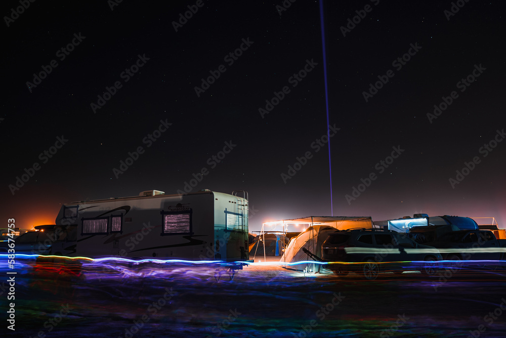 Night lights in the middle of a desert at the camp at BurningMan festival. Beautiful music festival in a desert.at night at the Burning Man Festival.