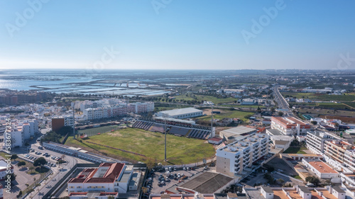 Aerial view of the Portuguese fishing tourist town of Olhao overlooking the Ria Formosa Marine Park. municipal stadium