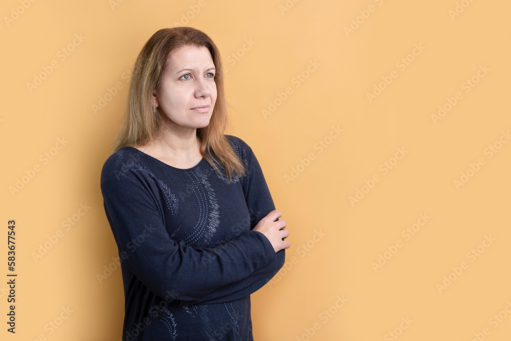 A woman on a yellow background looks up with hope, there are difficulties and problems in her life, but she is not disappointed, she believes and prays, she wants to be a good mother