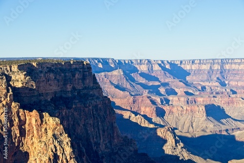 Early morning light casts shadows in the deeply eroded Grand Canyon, carved by the Colorado River thousands of feet below