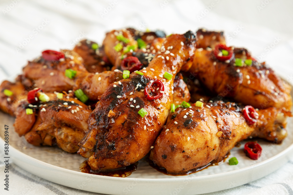 Homemade Easy Sticky Chicken Drumsticks on a Plate, side view. Close-up. Homemade Easy Sticky Chicken Drumsticks on a Plate, side view. Close-up.