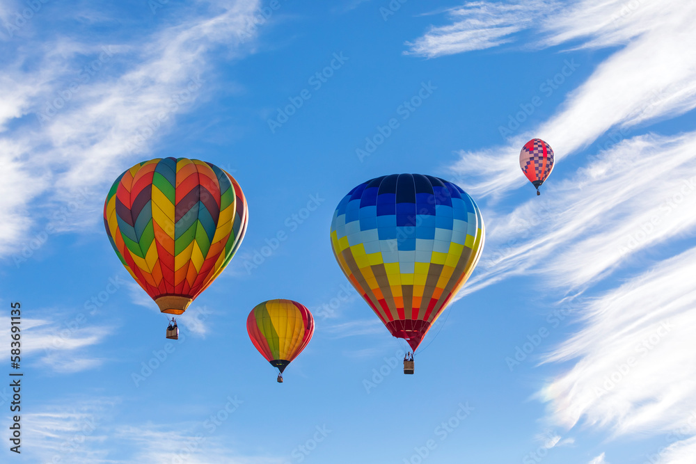 Colorful hot air balloons flying in the blue sky with white clouds Colorful hot air balloons flying in the blue sky with white clouds