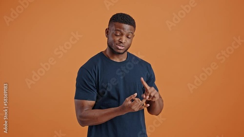 African man enumerates his plans, reasons on list-to-do, counts on his fingers and smiles at camera