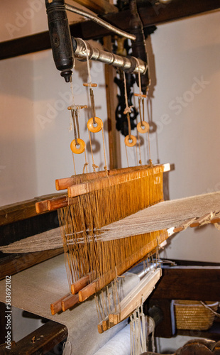 Historical and well-maintained ancient old wooden loom for weaving textile fabric.