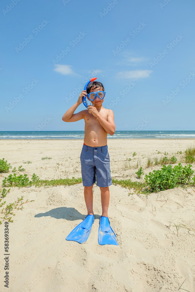 Young preteen boy playing at sunny beach with snorkel Stock Photo ...