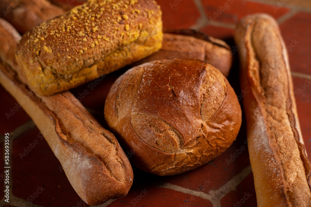 different types of French bread. Baguettes, bread with seeds on the kitchen table.