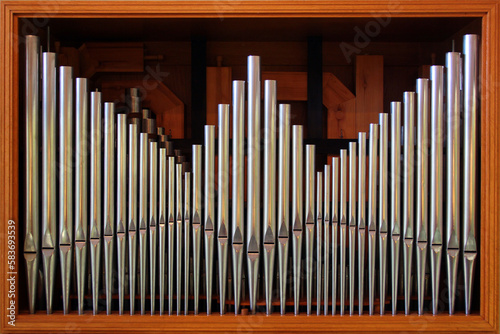 Organ pipes as background. Catholic classical music instrument in a church