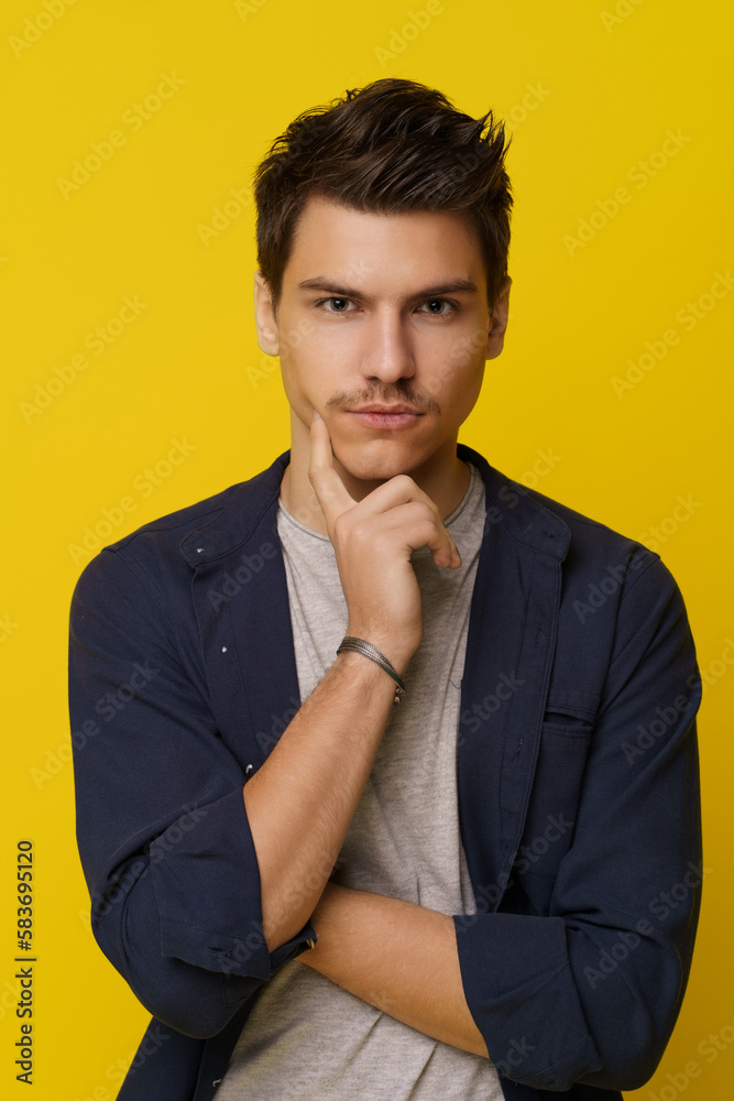 Smart student is deep in thought, brainstorming and contemplating ideas on bright yellow background, symbolizing creativity, innovation, and imagination. High quality photo
