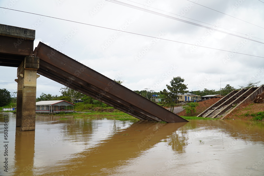 Collapsed bridge in Brazil of highway BR 319 over the Rio Curuca, A bridge pier was not anchored deep enough in the ground during construction and snapped off years later. Near Autazes, Amazonas. Collapsed bridge in Brazil of highway BR 319 over the Rio Curuca, A bridge pier was not anchored deep enough in the ground during construction and snapped off years later. Near Autazes, Amazonas.