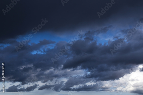 Storm cloudy dramatic sky with dark rain grey cumulus cloud and blue sky background texture, thunderstorm © Viktor Iden
