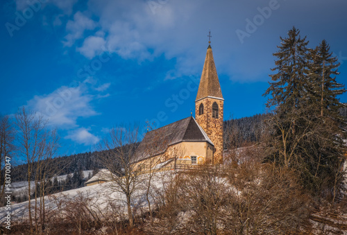Small church in St. Magdalena or Santa Maddalena in Geislergruppe or Gruppo dele Odle Italian Dolomites Alps mountains. January 2023 photo