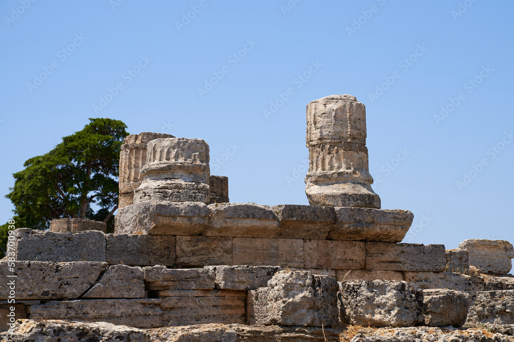 View of the remains of columns on the ruin from the Unesco World Heritage Site in Paestum. The facility is located in the Campania region of Italy. Ancient Greek culture in Italy.Part of Magna Grecia. View of the remains of columns on the ruin from the Unesco World Heritage Site in Paestum. The facility is located in the Campania region of Italy. Ancient Greek culture in Italy.Part of Magna Grecia.