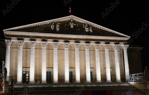 Facade of the French National Assembly illuminated at Night (Assemblee Nationale, Palais Bourbon, the French Parliament) after 2023 renovation - Paris, France photo