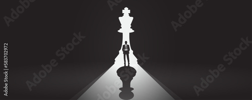 Experienced seasoned business career man employee in front of a bright chess king piece door with the shadow of a pawn - Being used, underachiever, change opportunity, career decision moment concept