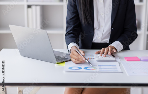 Businessman accounting working at office with calculator documents on his desk, doing planning analyzing the financial report, business plan investment, accounting finance analysis concept