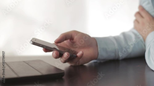 Close up of a person using a smartphone, swiping  with a thumb left and right