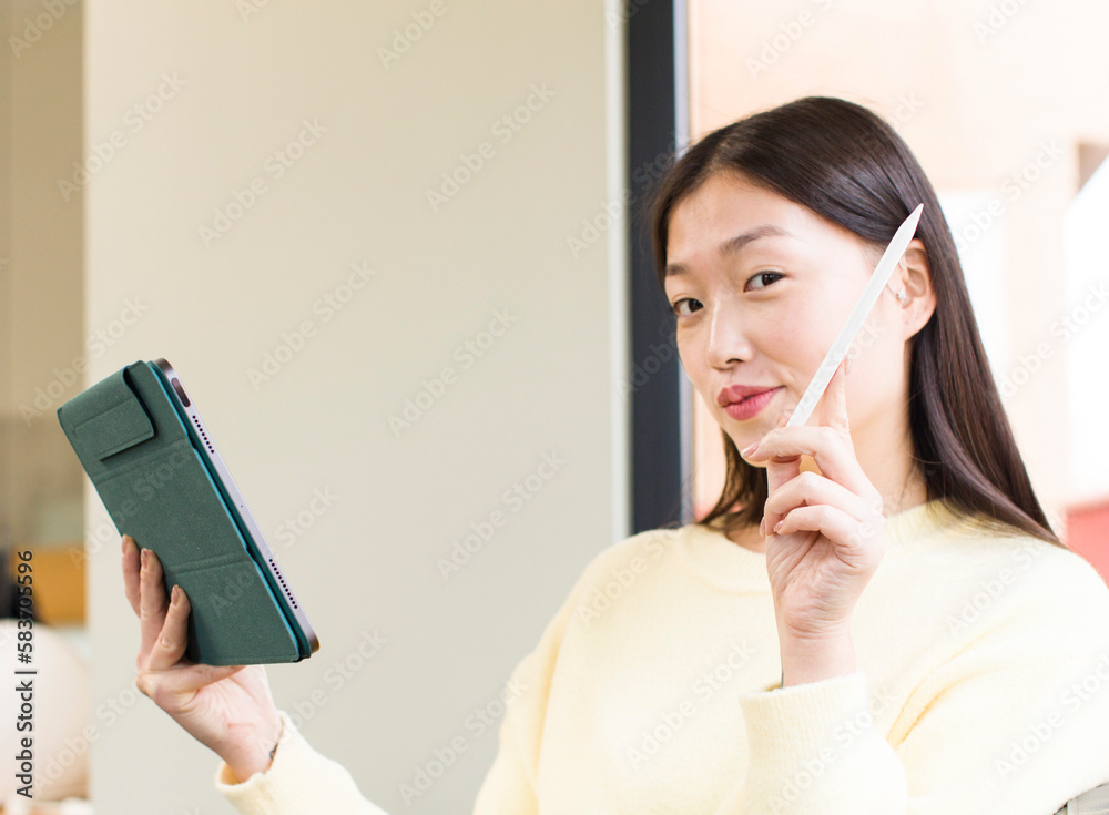 asian pretty woman using a touchscreen pad asian pretty woman using a touchscreen pad
