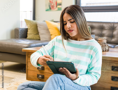 pretty latin woman using a pad at home