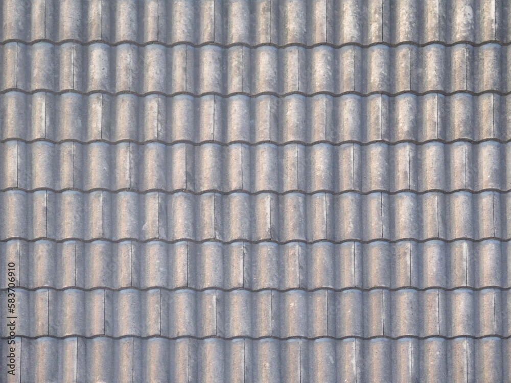 The texture of old grey roof tiles on a roof house for background and wallpapers The texture of old grey roof tiles on a roof house for background and wallpapers