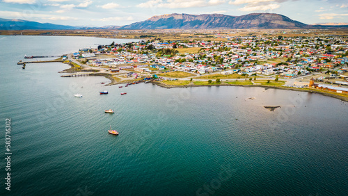 City of Puerto Natales Chile, Aerial Drone Above Town Buildings Amongst Patagonian Landscape of Idyllic Bay Water and Andean Cordillera Background