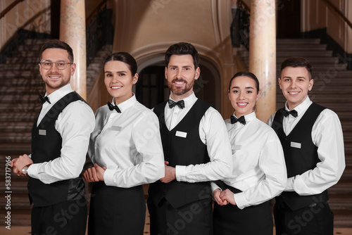 Group of trainees wearing formal clothes in hotel. Professional butler courses
