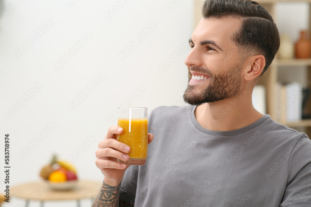 Handsome man with delicious smoothie at home. Space for text Handsome man with delicious smoothie at home. Space for text
