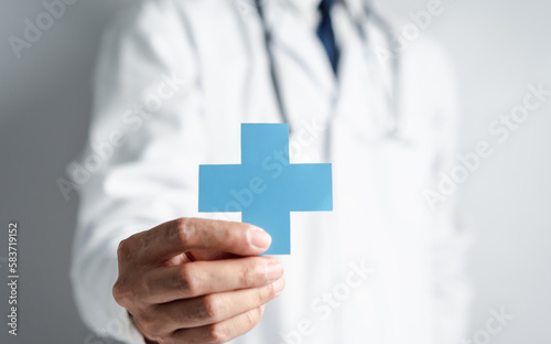 Doctor in white coat holding plus sign for assurance healthcare insurance symbol concept, Mental health care, medical check up concept.