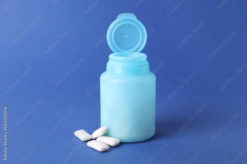 Jar with chewing gums on blue background Jar with chewing gums on blue background