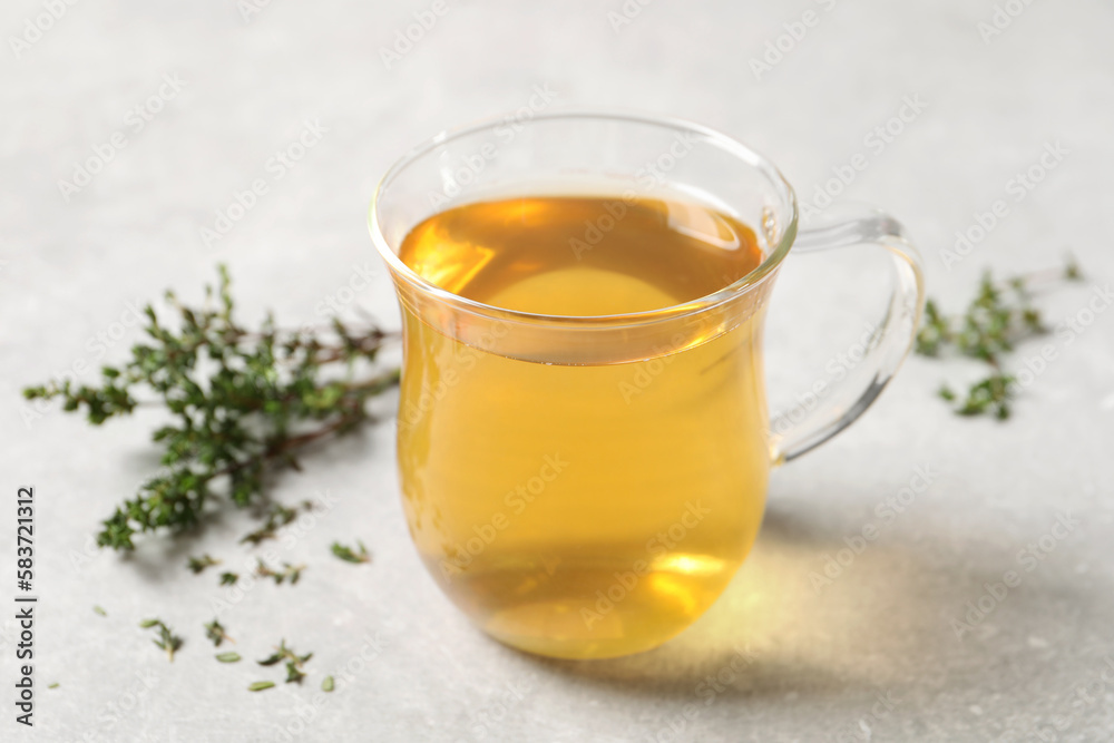 Aromatic herbal tea with thyme on light table