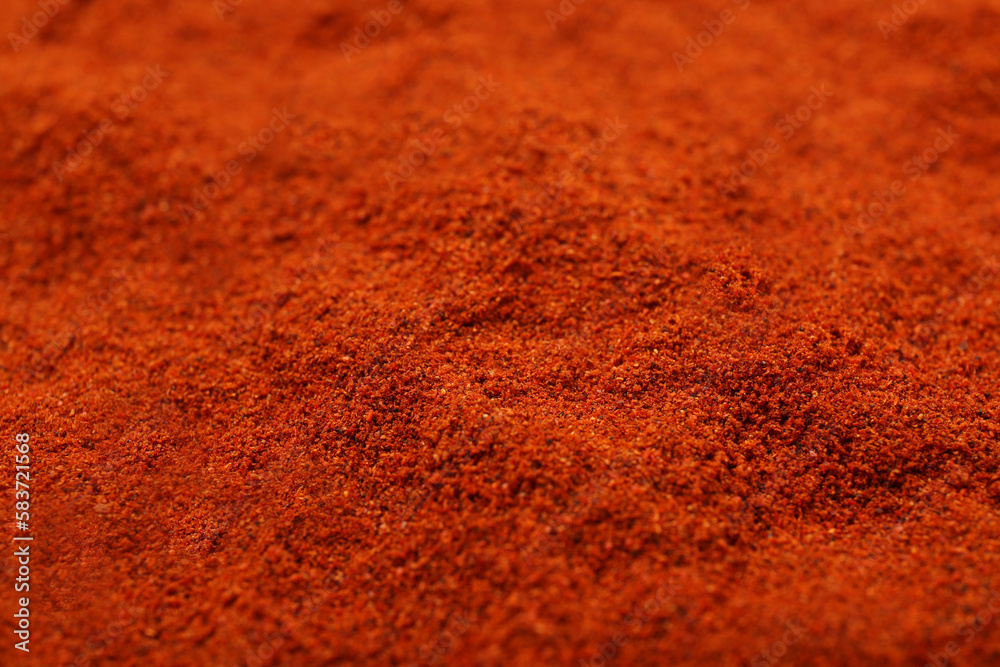 Aromatic paprika powder as background, closeup view Aromatic paprika powder as background, closeup view