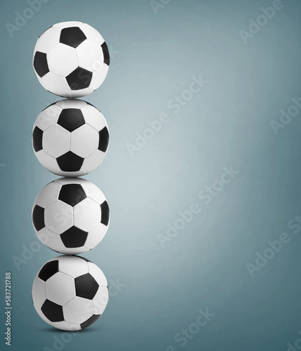 Fototapeta Naklejka Na Ścianę i Meble -  Stack of soccer balls on dusty light blue background. Space for text