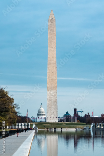 Washington D. C.  United States. November 29, 2022: Washington Monument with blue sky and reflection in the water.