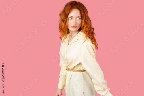Young curvy woman posing in a pink background isolated making up plan in mind, setting up an idea.