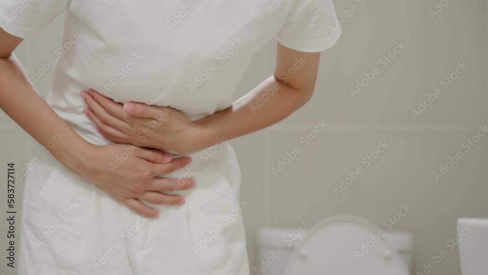 Constipation and diarrhea in bathroom. Hurt woman touch belly stomach