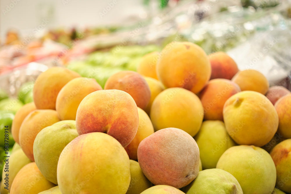 Stack of peaches in a fruit store. Bright image with copy space.