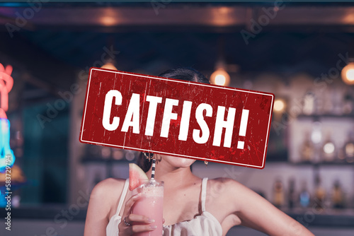 A catfish alert sign or someone pretending to be an attractive person. A fake profile using a stolen photo. A false identity used to pursue deceptive online romance. Catfishing detection concept. photo