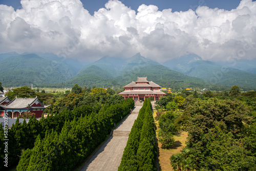 Chinese traditional pagodas and old buildings in a sunny day with mountains and blue sky on background. photo