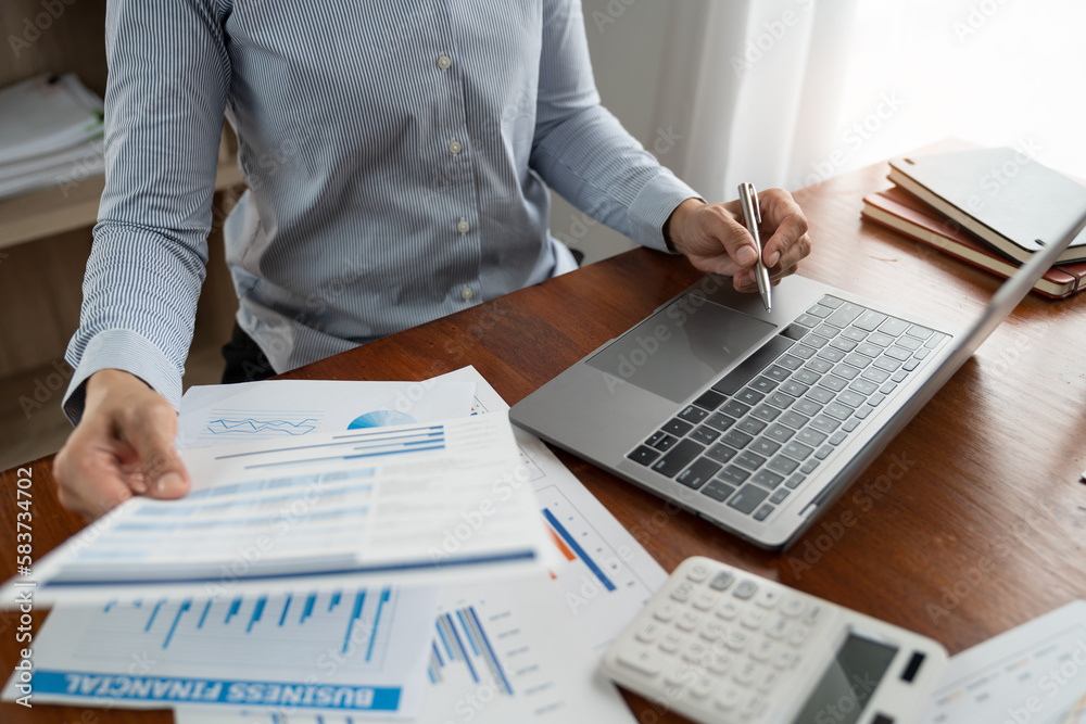 Fototapeta premium Businesswoman, accountant working on laptop computer in office Make accounting analysis report, real estate investment information, finance and tax system concept.
