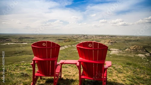tracking shot of lounge chairs over Grasslands National Park vista.