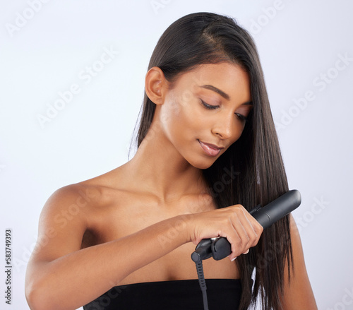 Natural  woman or hair straightener in studio for beauty self care or style treatment on white background. Face  Indian girl model or salon spa equipment for ironing in grooming routine for styling