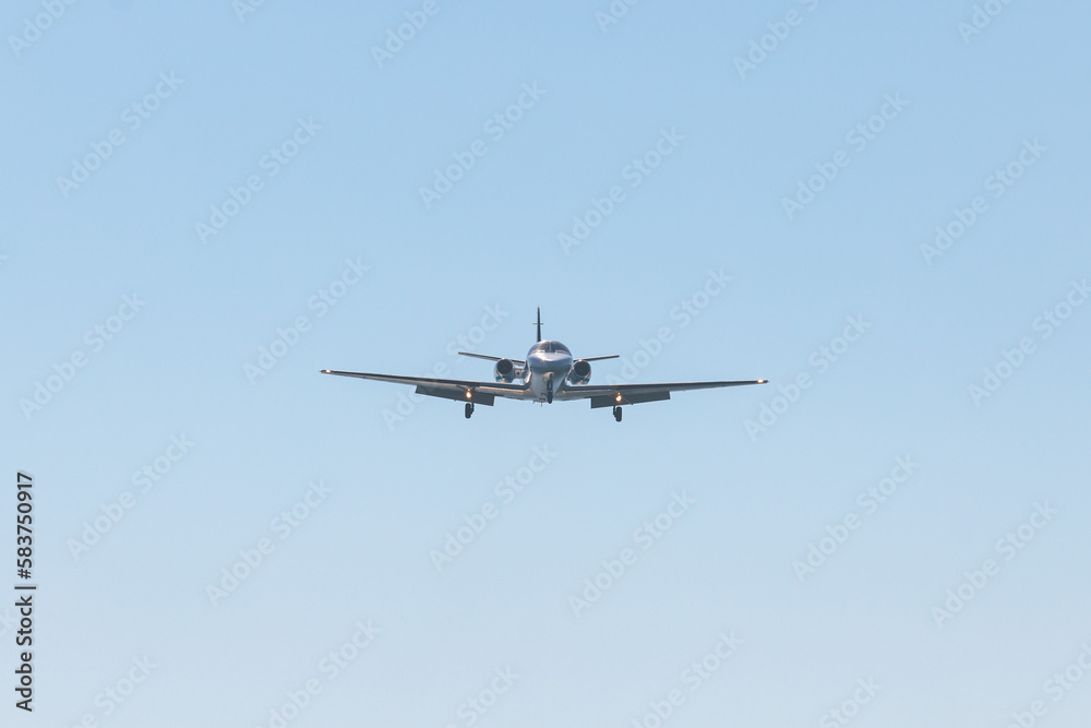 View of modern private reactive plane aircraft in flight, business airliner jet airplane before in the air with mountains in the background in a summer sunny day, corporate jet view View of modern private reactive plane aircraft in flight, business airliner jet airplane before in the air with mountains in the background in a summer sunny day, corporate jet view