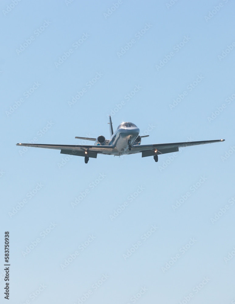 View of modern private reactive plane aircraft in flight, business airliner jet airplane before in the air with mountains in the background in a summer sunny day, corporate jet view View of modern private reactive plane aircraft in flight, business airliner jet airplane before in the air with mountains in the background in a summer sunny day, corporate jet view