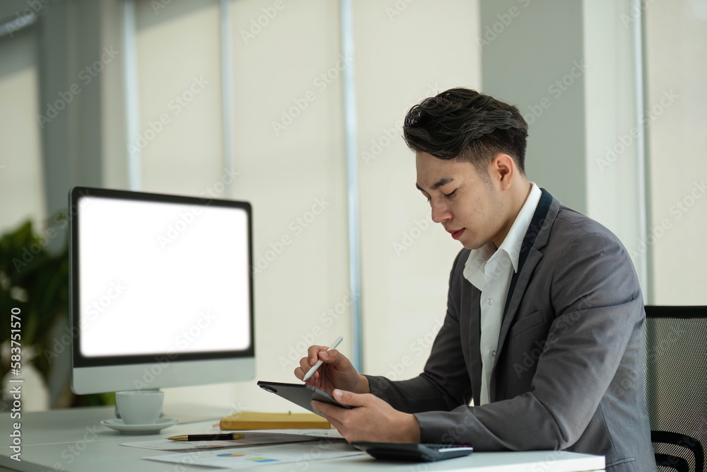 Business man working analyst of work on lnotebook pc while sitting at wooden table. Business man analyze stock report on notebook pc screen Business man working analyst of work on lnotebook pc while sitting at wooden table. Business man analyze stock report on notebook pc screen