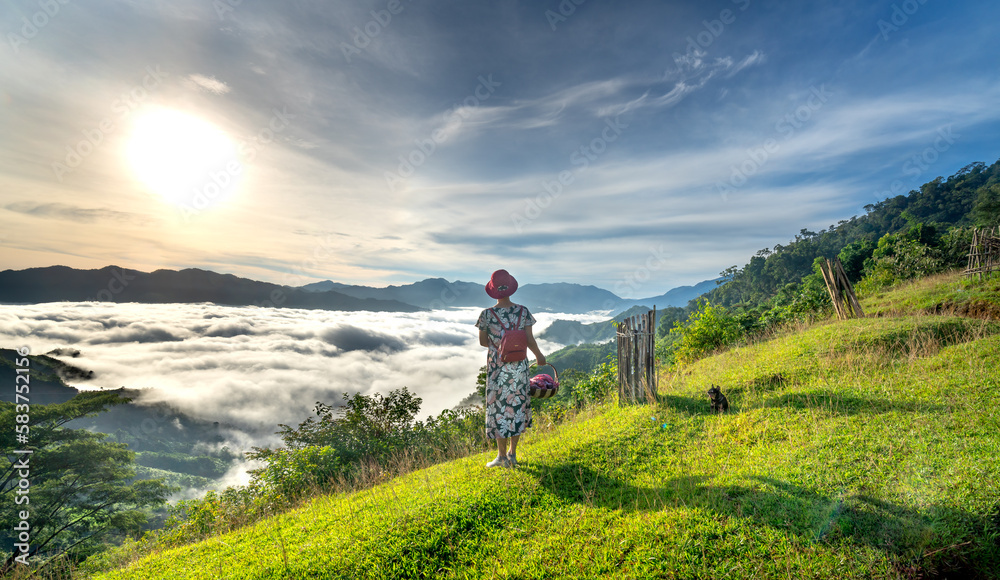 A female tourist looks at the white cloud valley of the Tak Po mountain range in Tra Tap commune, Nam Tra My district, Quang Nam province, Vietnam