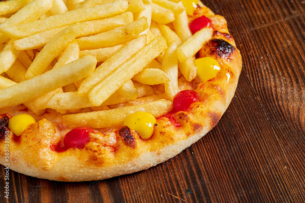 pizza with french fries on the wooden background pizza with french fries on the wooden background