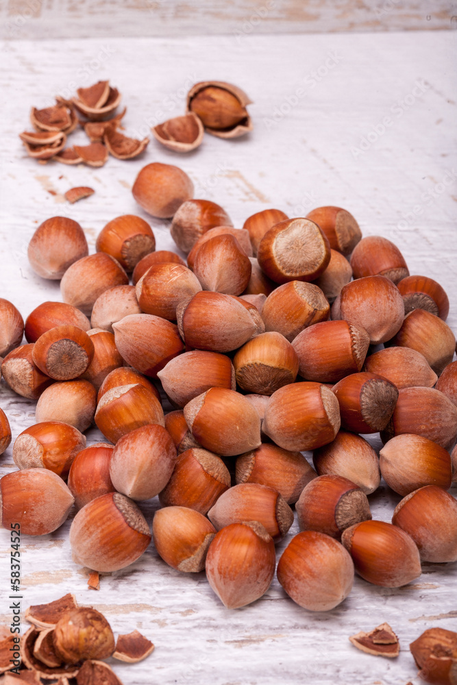 Close up photo of raw nuts on white wooden vintage background