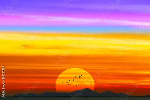 Sunrise or sunset red color and colorful cloud with birds flying
