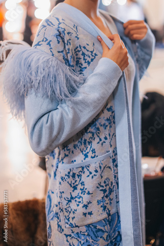 Female figure in knitting blue elegant autumn cardigan. Fashion collection details