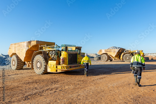 Two miners heading to their trucks at a mine site