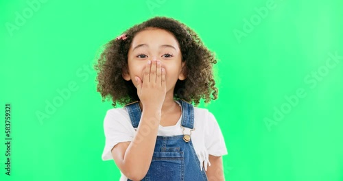 Wow, surprise and children with a girl on a green screen background standing hand over mouth. Portrait, face and gasp with an adorable little female child hearing gossip or a rumor on chromakey